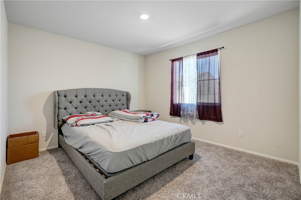24871 Tiger Avenue Moreno Valley, CA 92551 - Photo 8 of 13 a bedroom with a bed and window