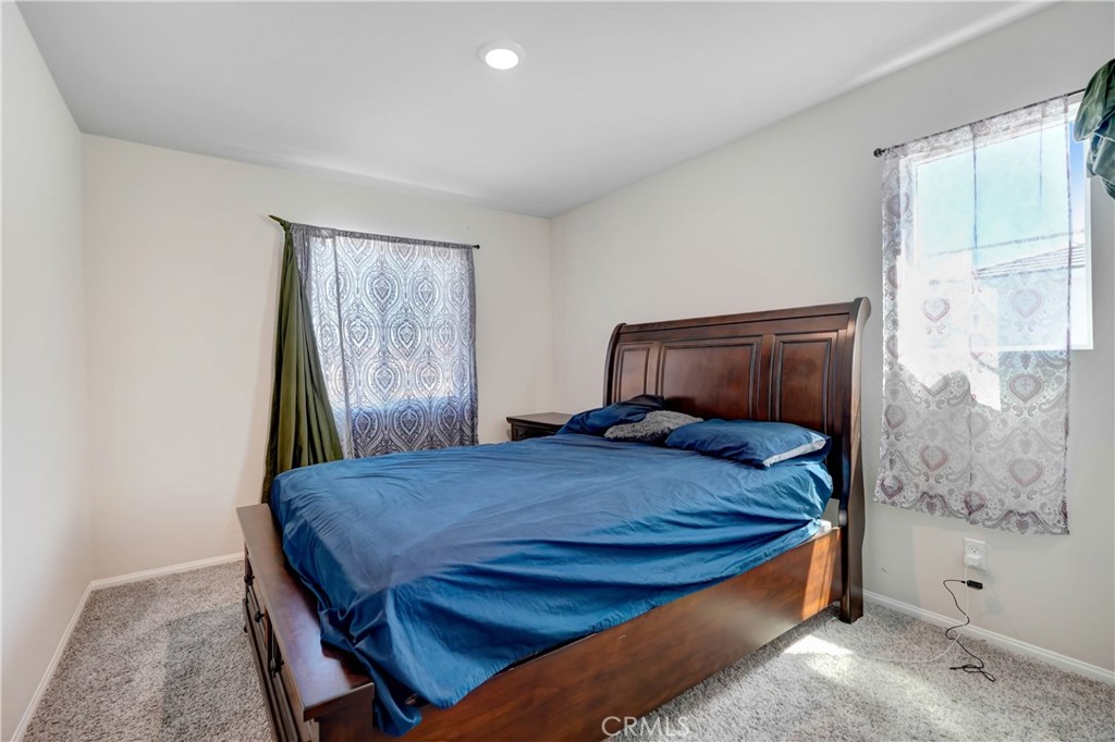 24871 Tiger Avenue Moreno Valley, CA 92551 - Photo 10 of 13 a bedroom with a bed and a window