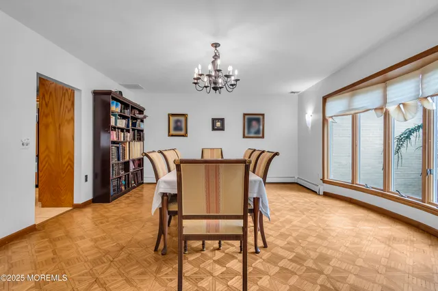 a view of a dining room with furniture and a window