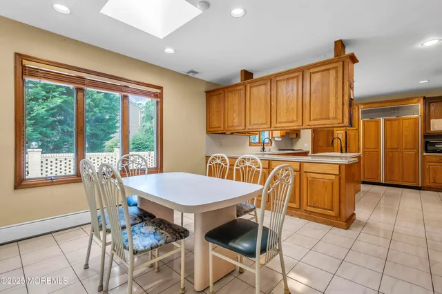 a table and chairs in a room next to a window