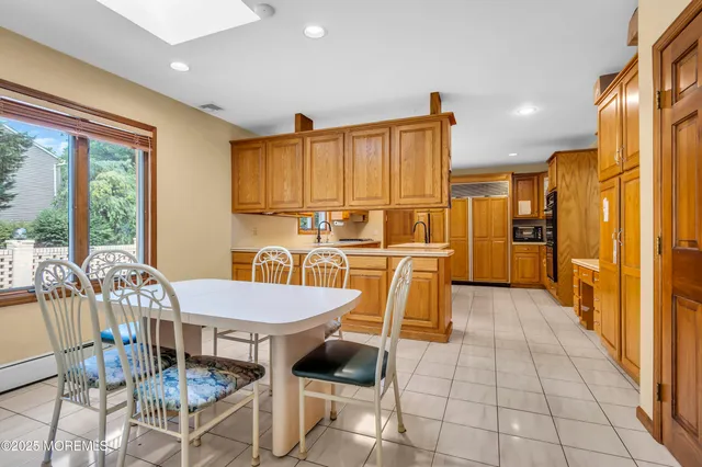 a kitchen with granite countertop a refrigerator and dining table
