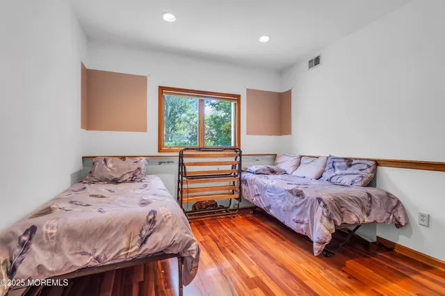 a bedroom with a bed and a night stand