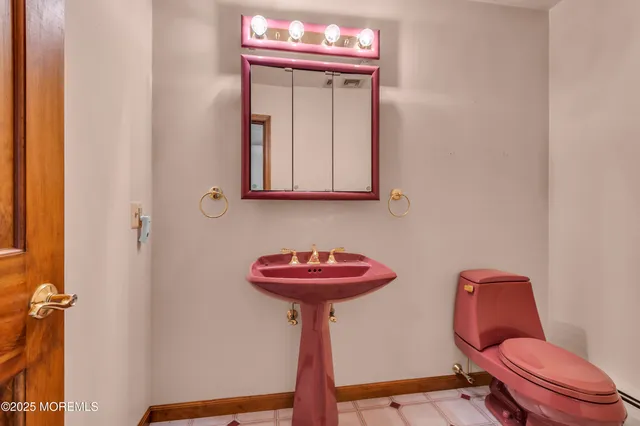 a bathroom with a sink a toilet and mirror