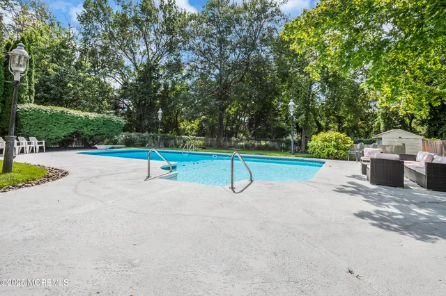 a view of a house with swimming pool and yard