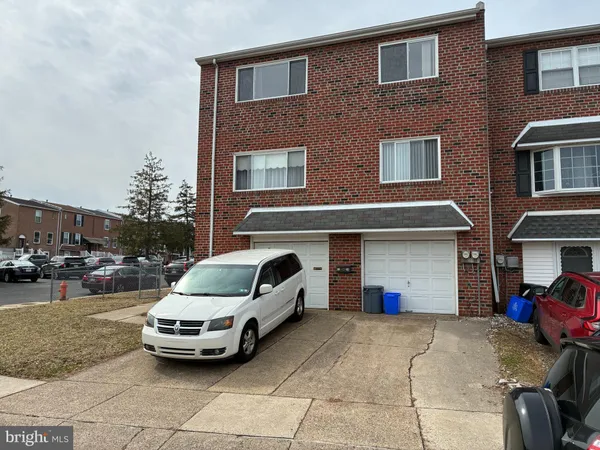 a car parked in front of a brick house
