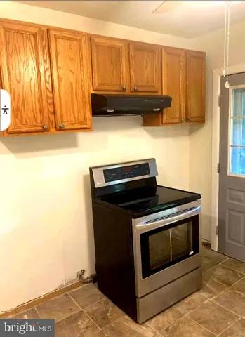 a kitchen with granite countertop cabinets and steel appliances