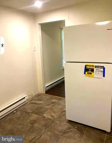 a view of a refrigerator in a kitchen