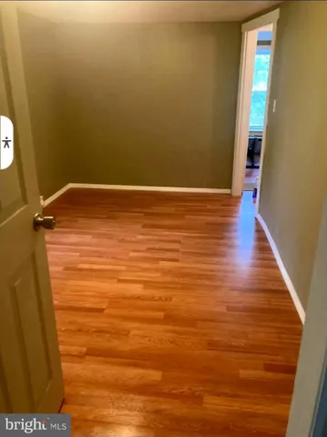 a view of room with wooden floor