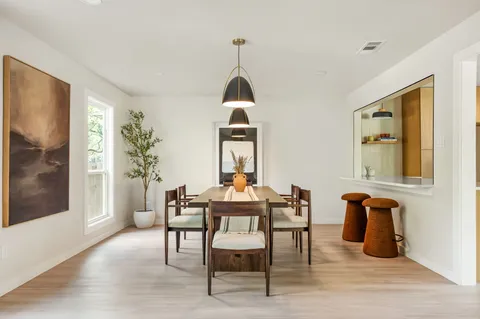 a dining room with furniture and wooden floor