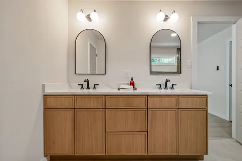 a bathroom with 2 sink and a mirror