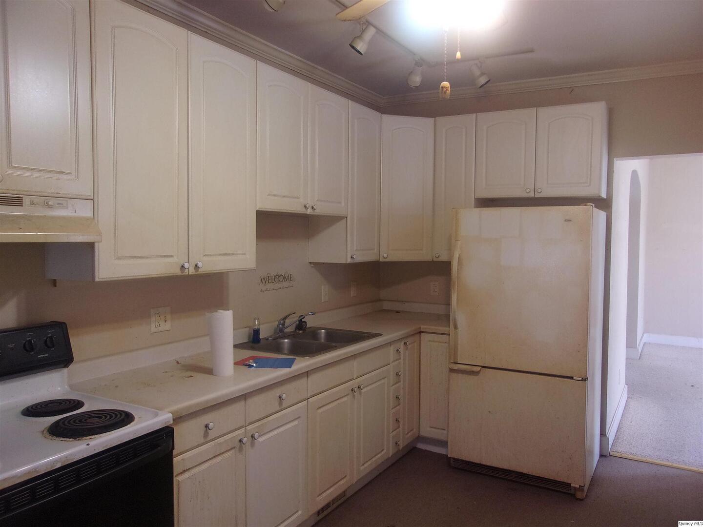 740 South 14th Street Quincy, IL 62301 - Photo 8 of 20 a kitchen with refrigerator and cabinets