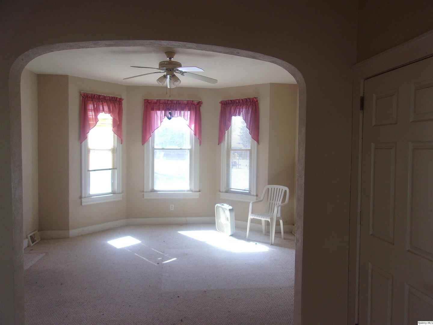 740 South 14th Street Quincy, IL 62301 - Photo 9 of 20 a very nice looking room with windows and chandelier