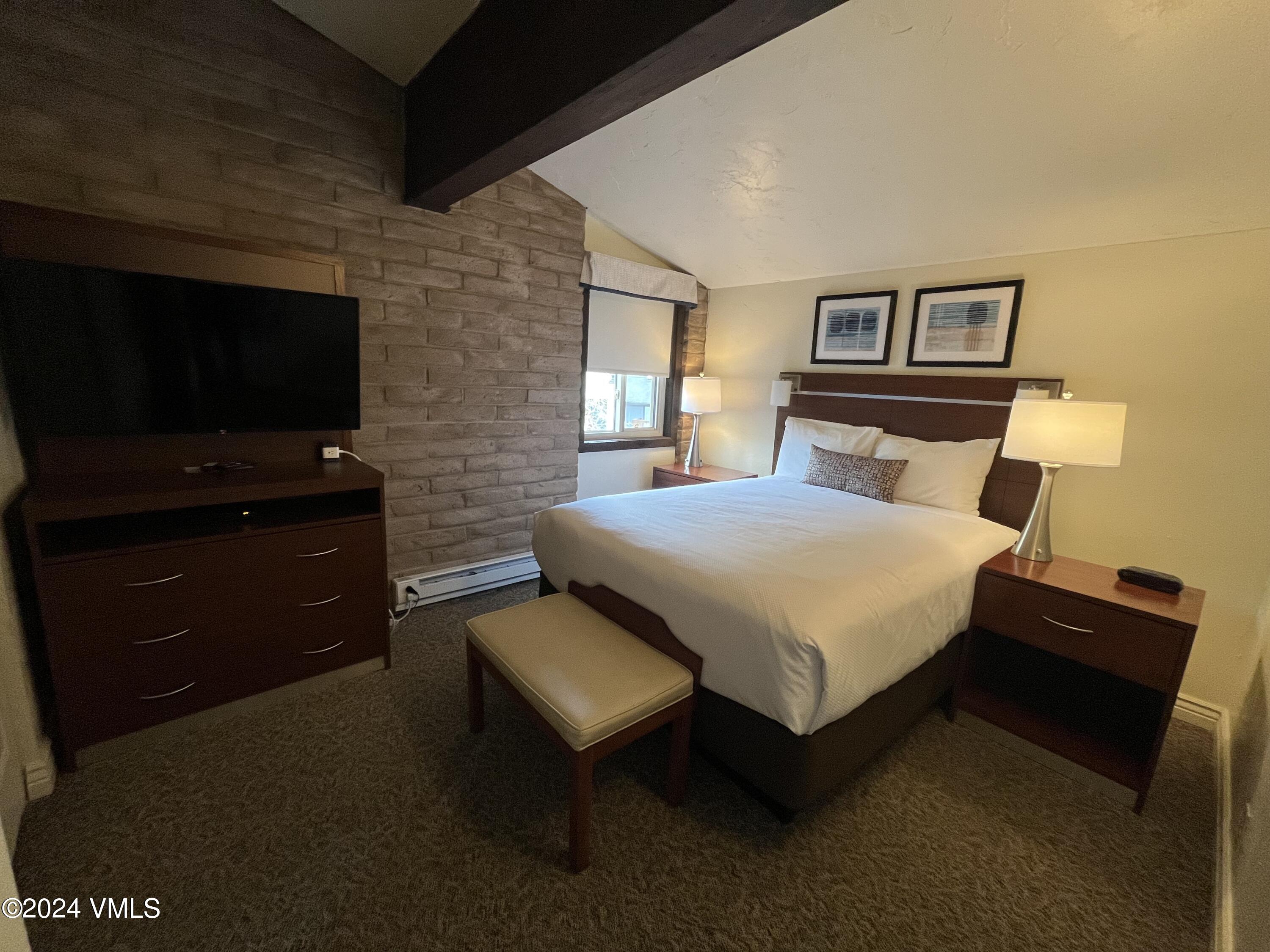 1020 Vail View Drive, Unit 340241 Vail, CO 81657 - Photo 16 of 32 a bedroom with a bed and a flat screen tv