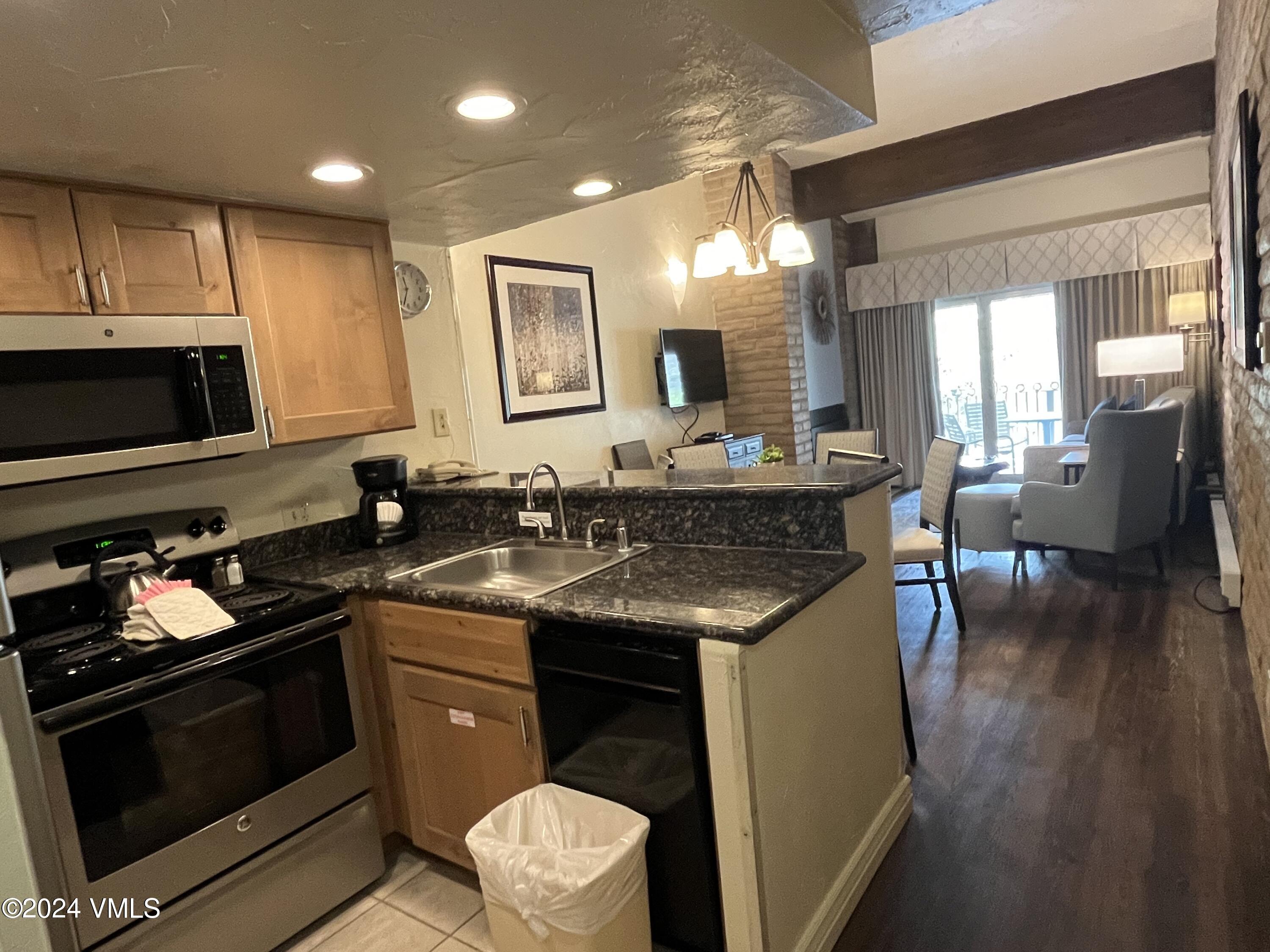 1020 Vail View Drive, Unit 340241 Vail, CO 81657 - Photo 2 of 32 a kitchen with a sink stove and cabinets