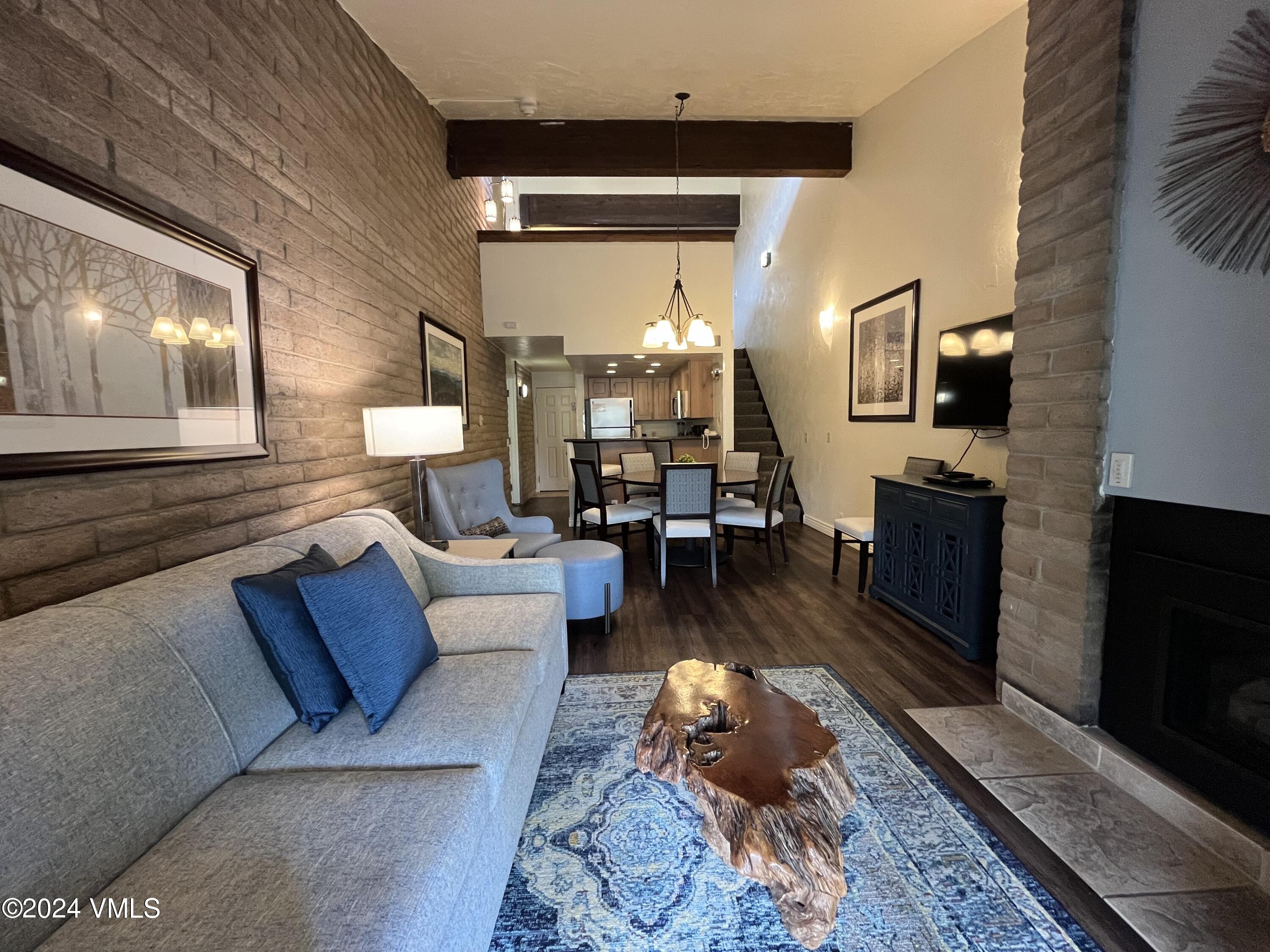 1020 Vail View Drive, Unit 340241 Vail, CO 81657 - Photo 6 of 32 a living room with furniture and a flat screen tv