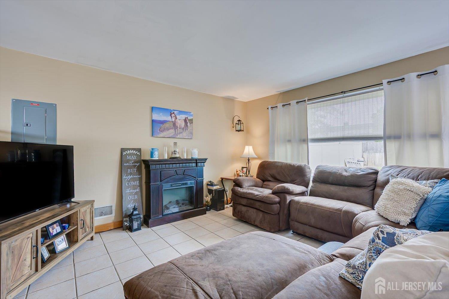44 McKinley Avenue Colonia, NJ 07067 - Photo 11 of 38 a living room with furniture and a flat screen tv