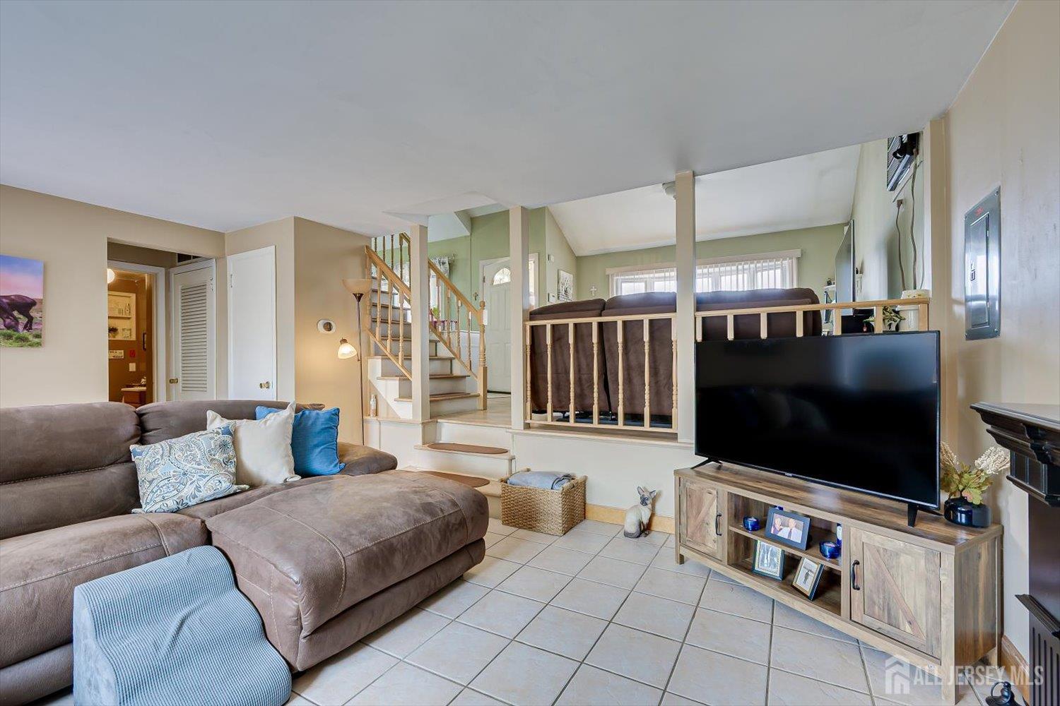 44 McKinley Avenue Colonia, NJ 07067 - Photo 16 of 38 a living room with furniture and a flat screen tv