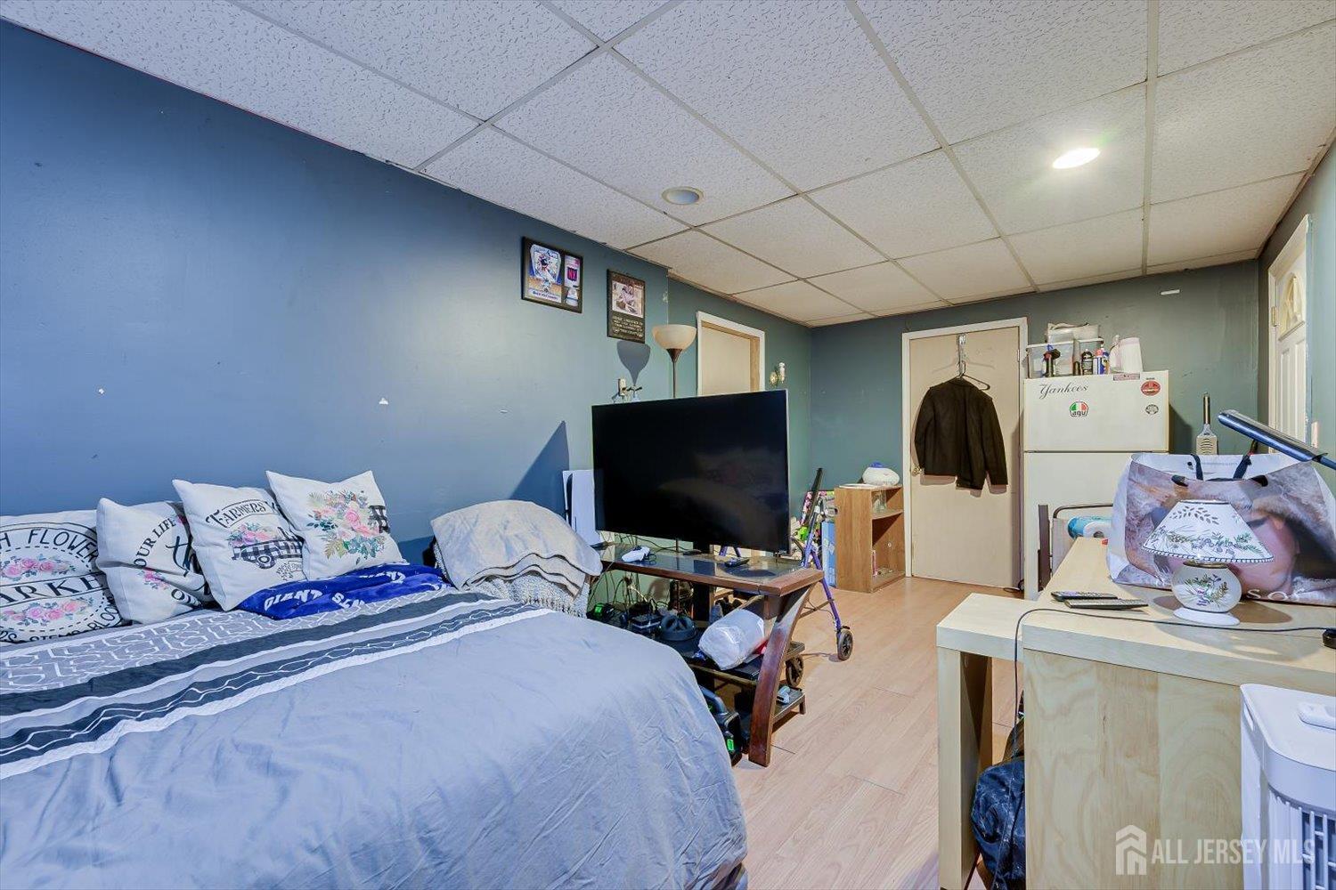 44 McKinley Avenue Colonia, NJ 07067 - Photo 18 of 38 a bedroom with furniture and a flat screen tv