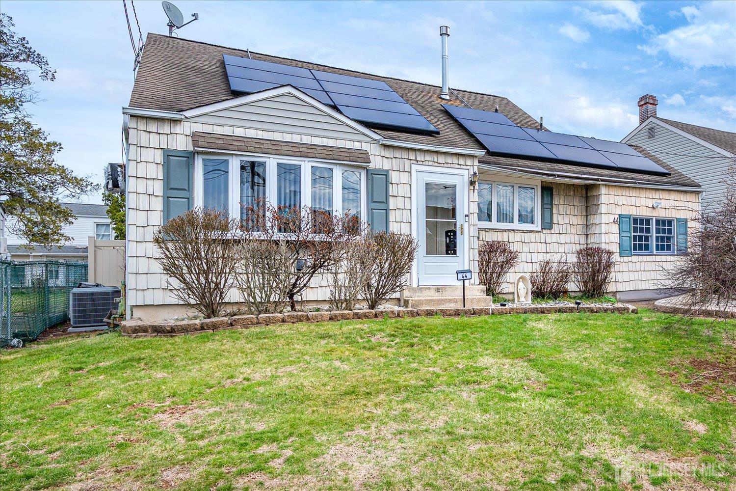 44 McKinley Avenue Colonia, NJ 07067 - Photo 2 of 38 a front view of house with yard and outdoor seating