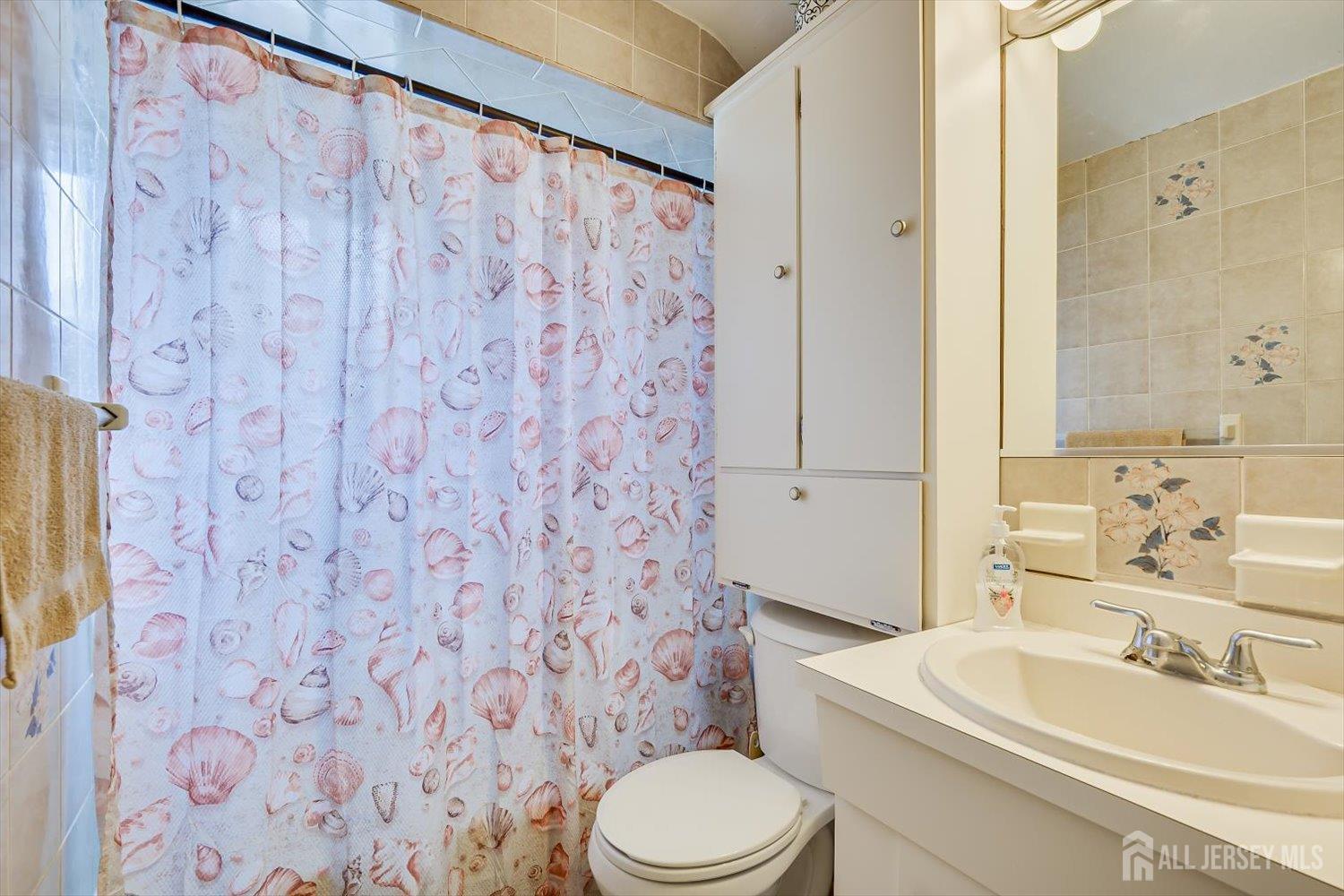 44 McKinley Avenue Colonia, NJ 07067 - Photo 21 of 38 a bathroom with a sink and a mirror