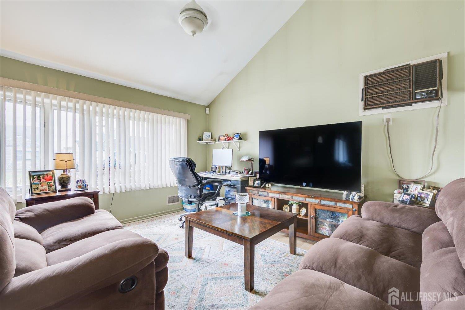 44 McKinley Avenue Colonia, NJ 07067 - Photo 7 of 38 a living room with furniture and a flat screen tv