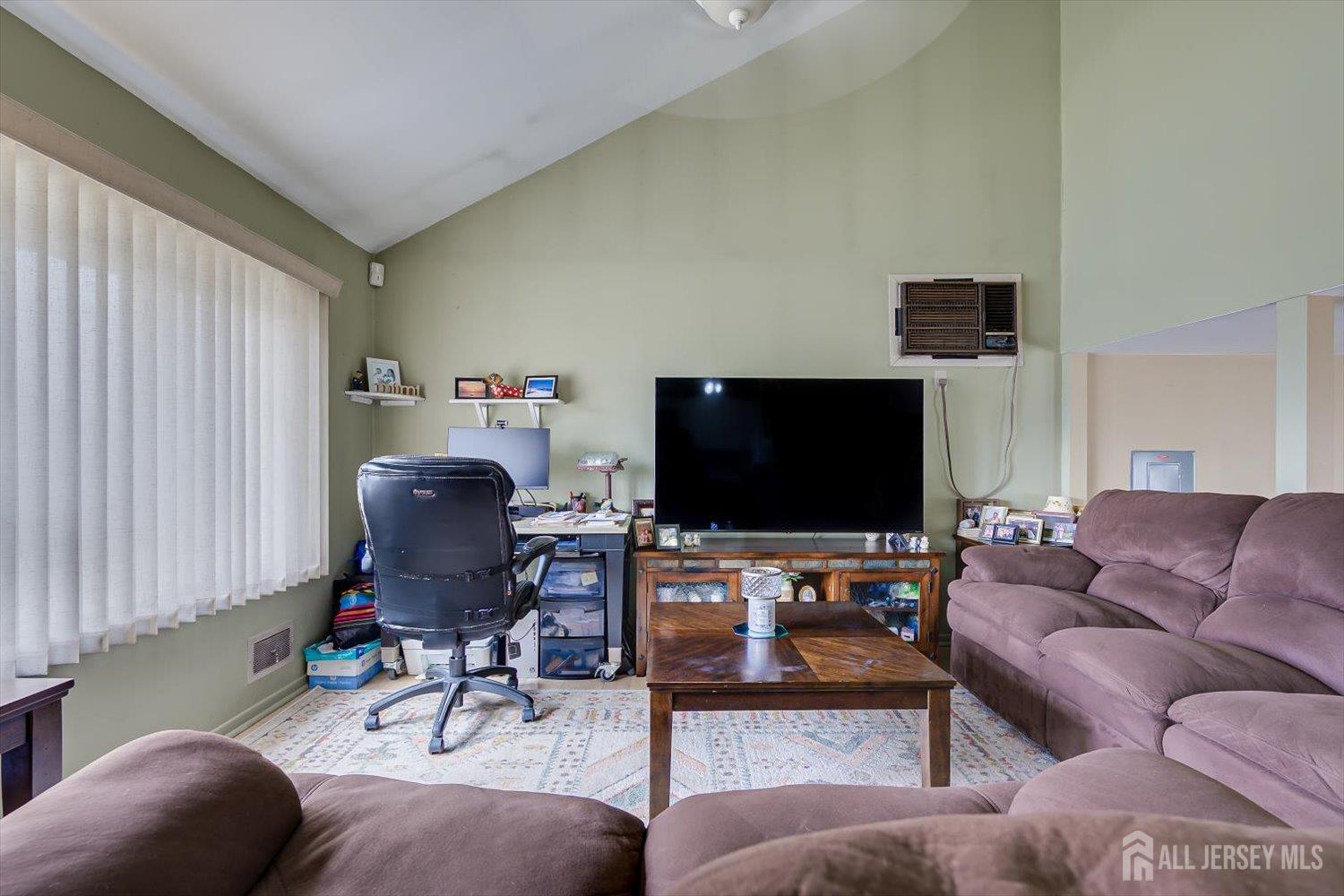 44 McKinley Avenue Colonia, NJ 07067 - Photo 9 of 38 a living room with furniture and a flat screen tv