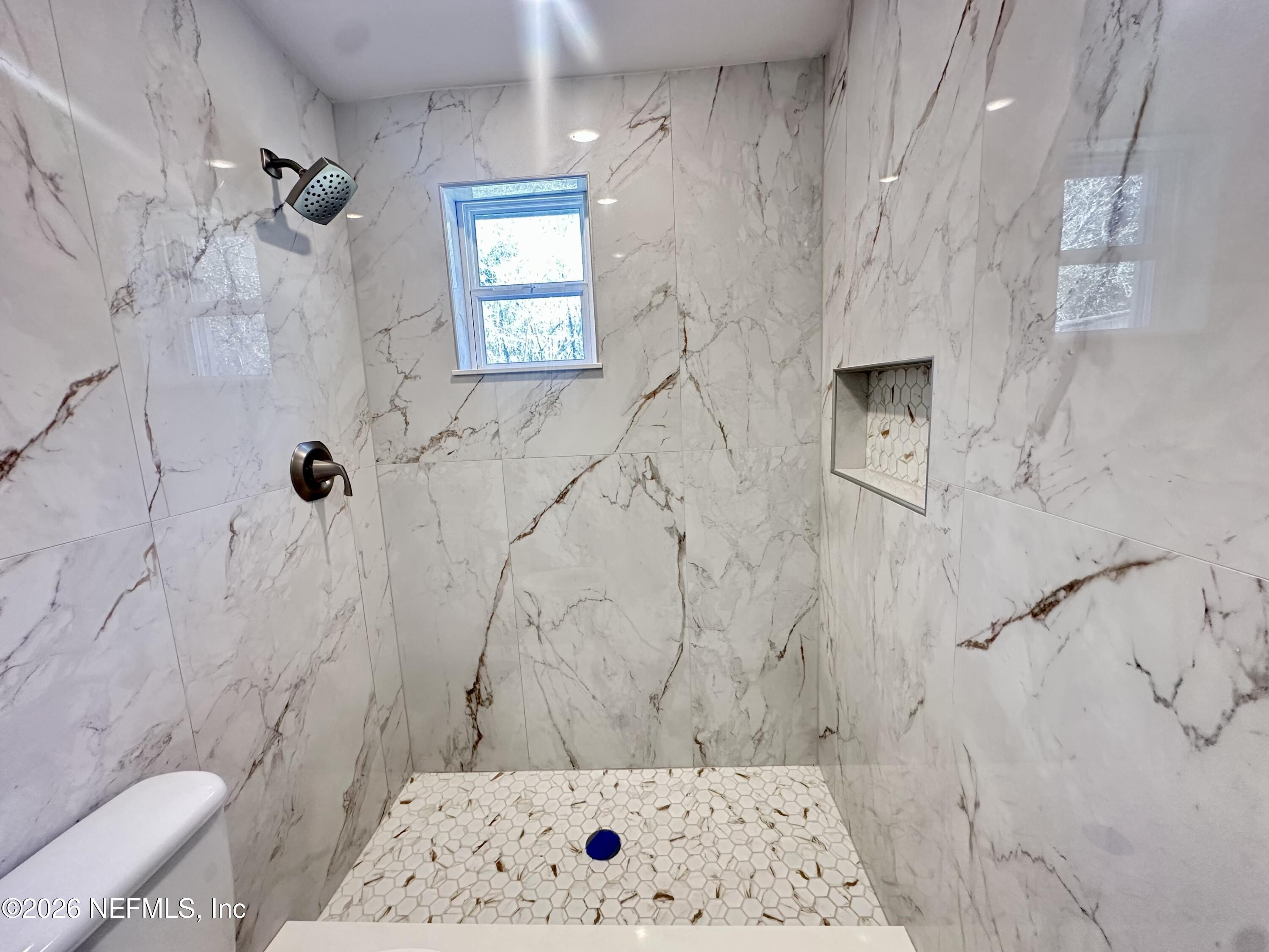 11335 Wingate Road North Jacksonville, FL 32218 - Photo 11 of 17 a bathroom with a bathtub and shower