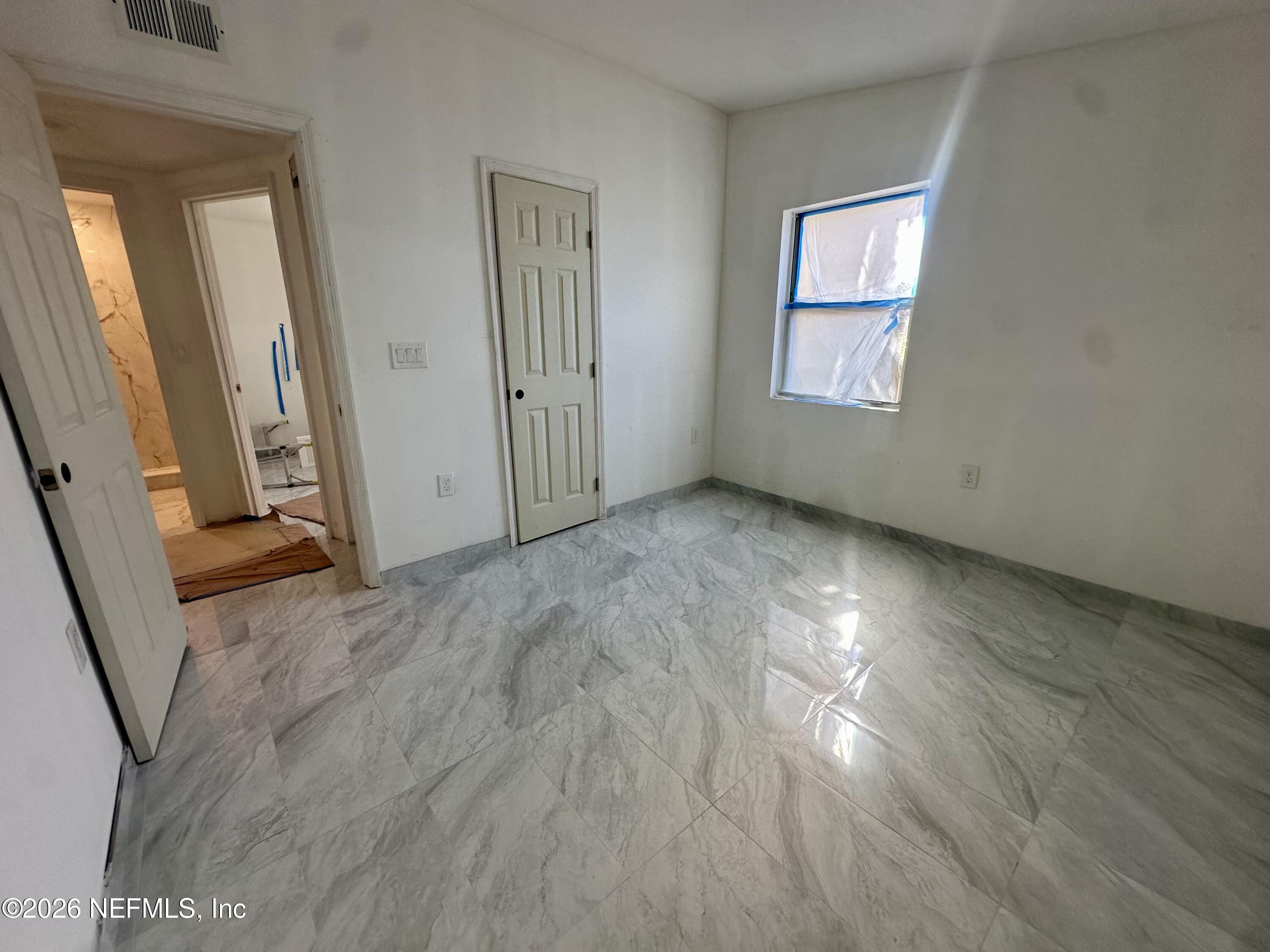11335 Wingate Road North Jacksonville, FL 32218 - Photo 13 of 17 a view of an empty room with wooden floor and a window