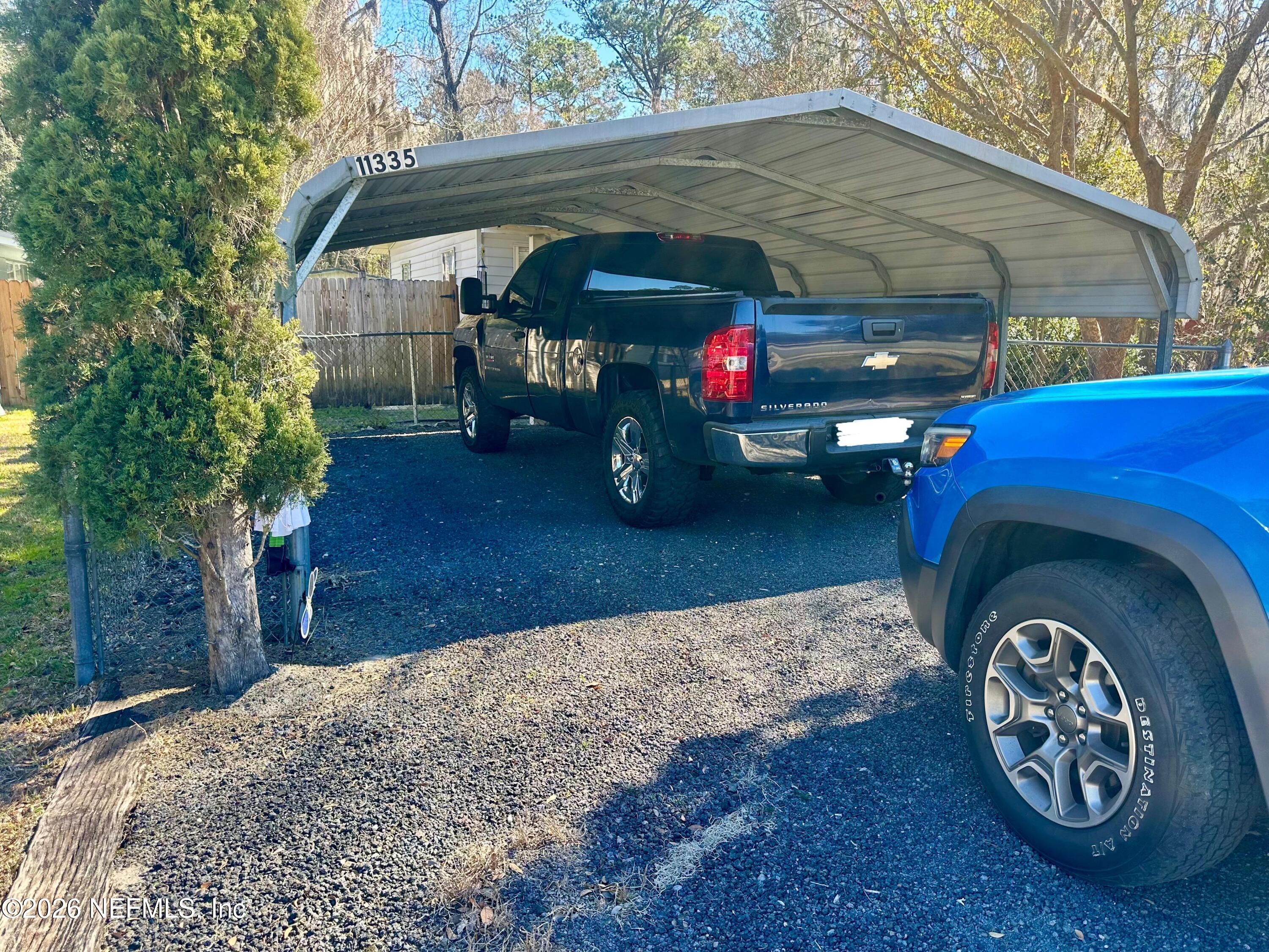 11335 Wingate Road North Jacksonville, FL 32218 - Photo 3 of 17 a front view of a house with a garden