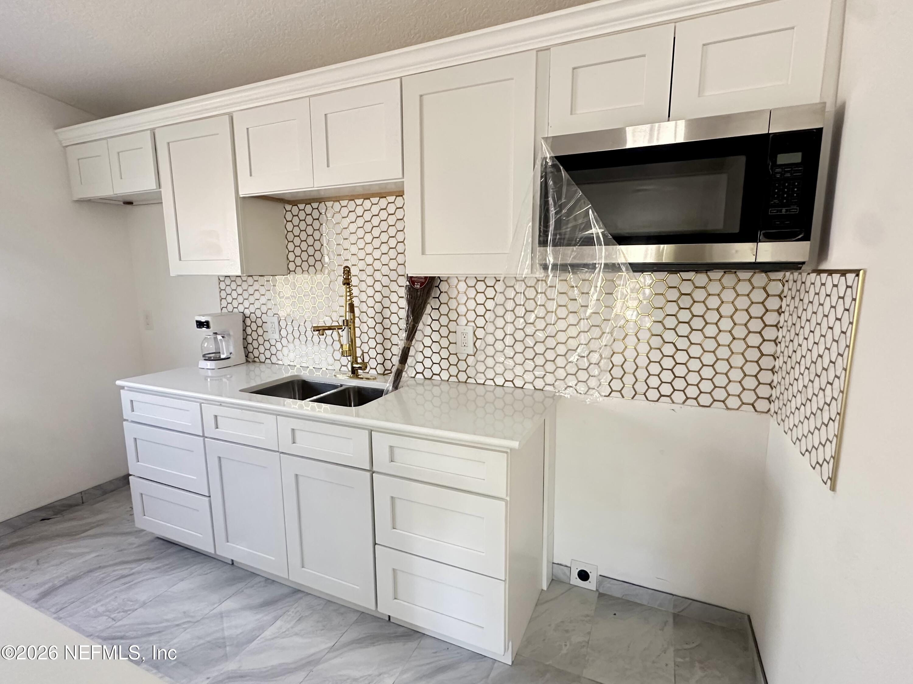 11335 Wingate Road North Jacksonville, FL 32218 - Photo 6 of 17 a kitchen with a sink and cabinets