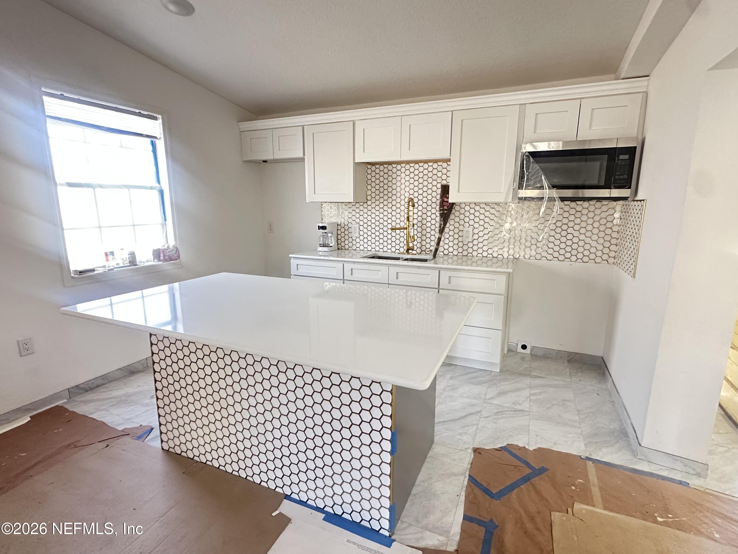 11335 Wingate Road North Jacksonville, FL 32218 - Photo 8 of 17 a kitchen with stainless steel appliances kitchen island granite countertop a sink and a granite counter tops