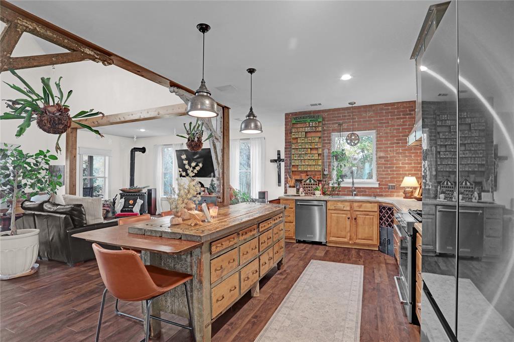 7070 Armadillo Rdg Road McKinney, TX 75071 - Photo 34 of 34 a kitchen with a table chairs stove and cabinets