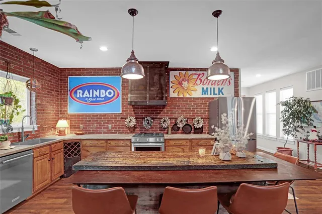 a kitchen with a table chairs stove and cabinets