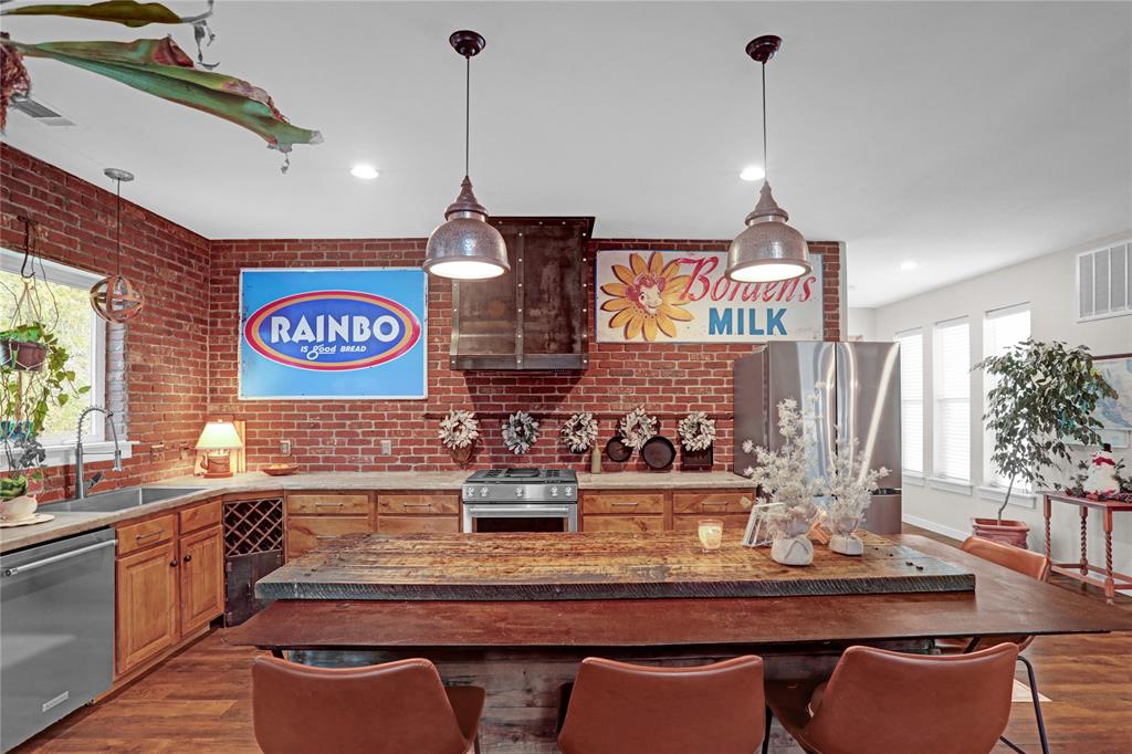 7070 Armadillo Rdg Road McKinney, TX 75071 - Photo 11 of 34 a kitchen with a table a stove and cabinets