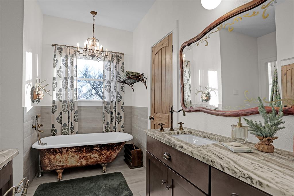 7070 Armadillo Rdg Road McKinney, TX 75071 - Photo 13 of 34 a bathroom with a granite countertop sink a toilet and a mirror