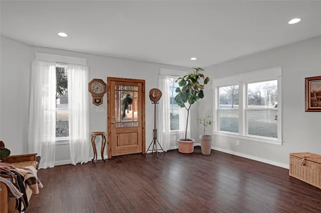 a view of an entryway with wooden floor