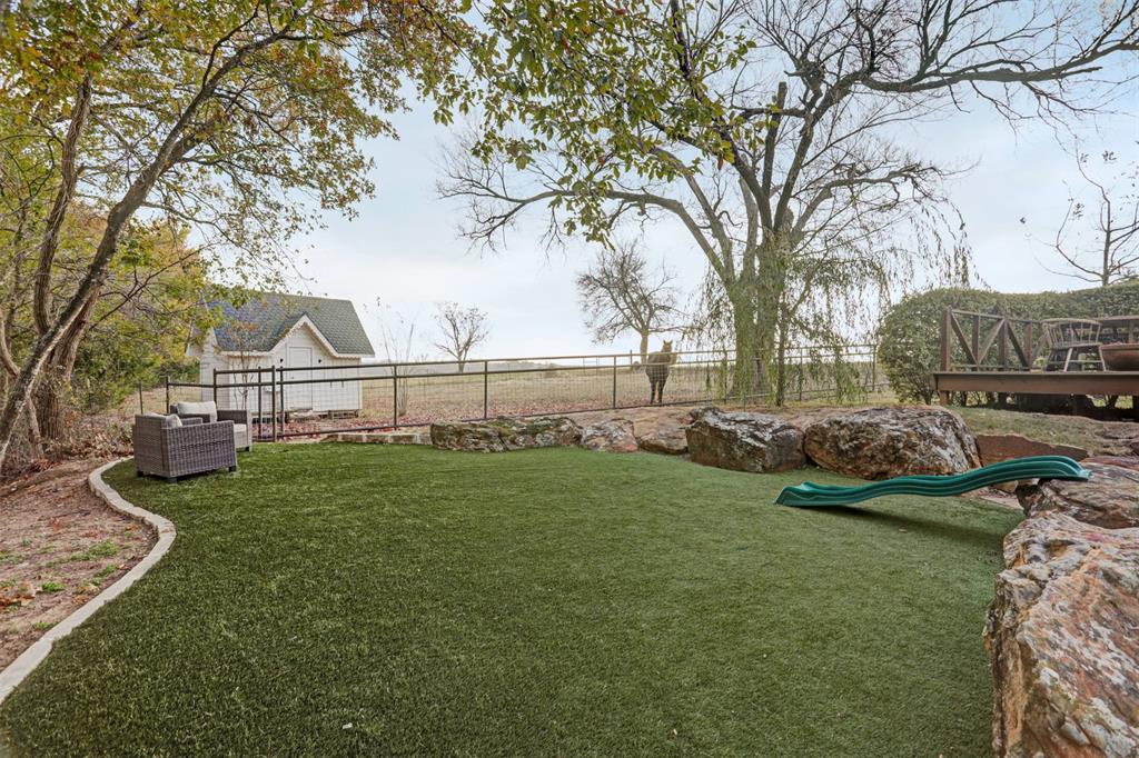 7070 Armadillo Rdg Road McKinney, TX 75071 - Photo 31 of 34 a view of a garden with grass and a large tree