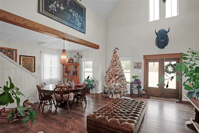 a living room with furniture and a chandelier