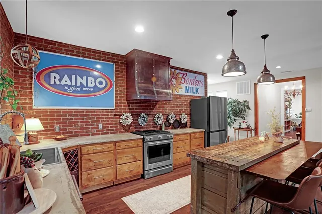 a kitchen with stainless steel appliances granite countertop a stove a refrigerator and a refrigerator