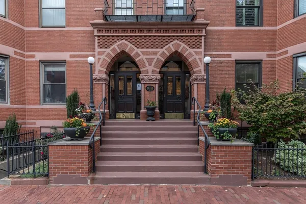 a front view of a house with potted plants