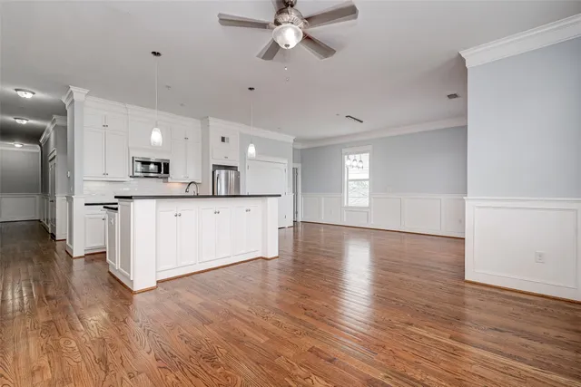 a view of a kitchen with a sink hardwood floor and a kitchen view