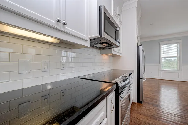 a view of a storage and utility room with wooden floor