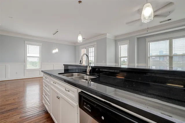 a large kitchen with granite countertop a sink and a stove