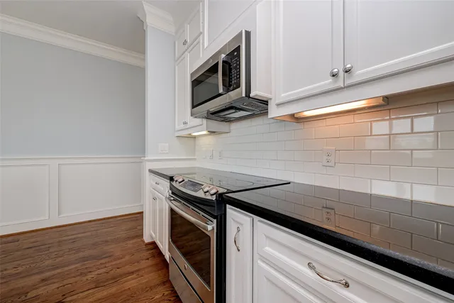 a kitchen with stainless steel appliances granite countertop a stove and a microwave