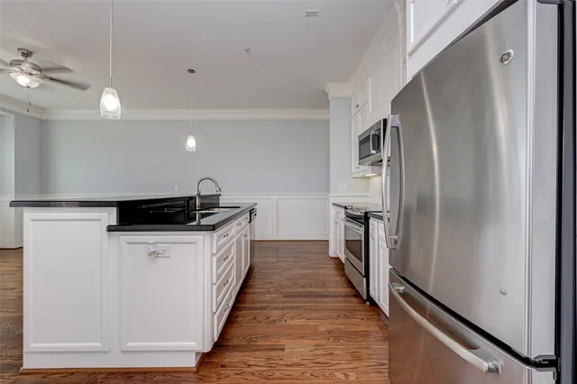 a kitchen with a refrigerator and a sink