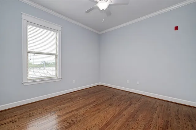 wooden floor in an empty room with a window