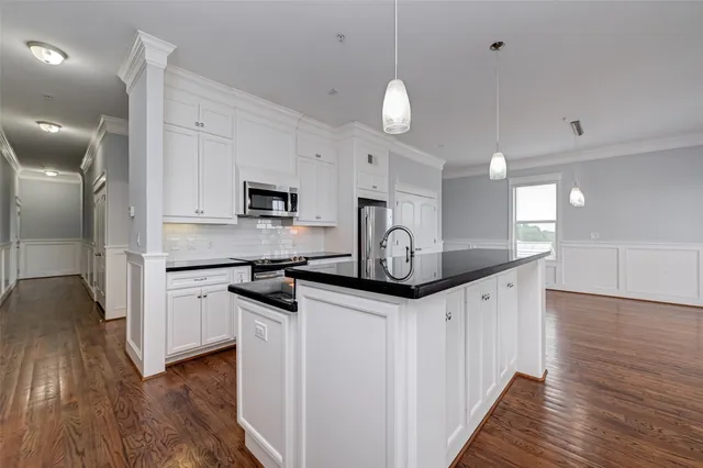 a kitchen with granite countertop a sink and steel appliances