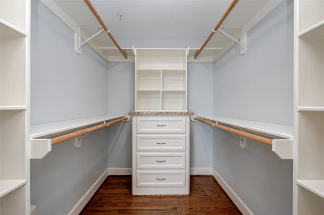 a view of walk in closet with empty racks
