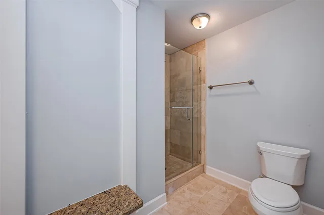 a bathroom with a toilet and shower
