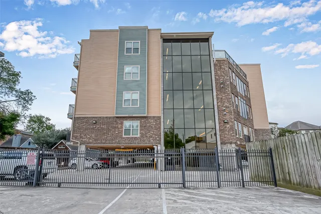 a view of a brick building next to a yard